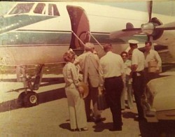 Donald E. Warfield (left of pilot in hat) waits as his guest fellow corporate executives and their wives gather to board B&R jet. Return trip photo taken by daughter Nancy Warfield.